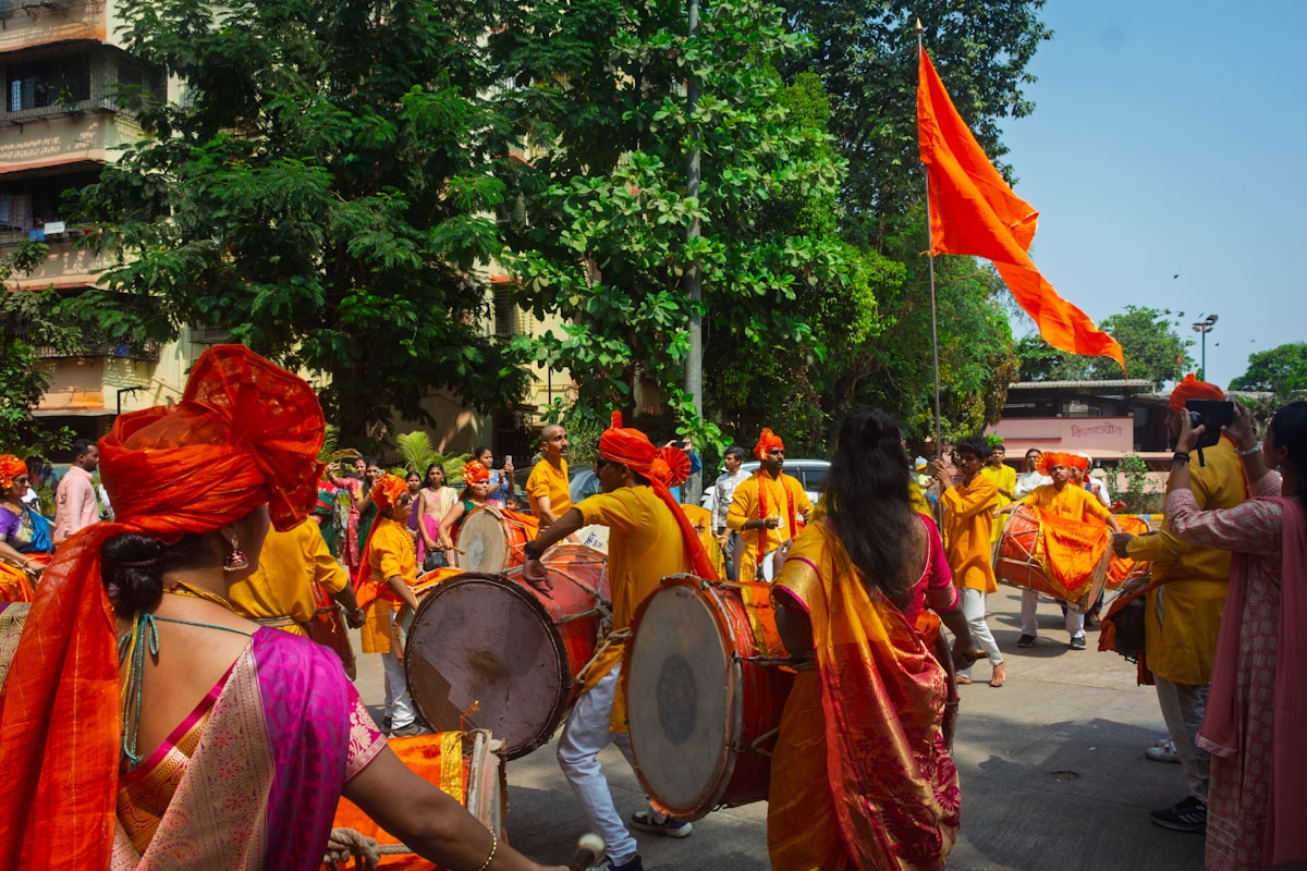 A group playing devotional music together in traditional dress