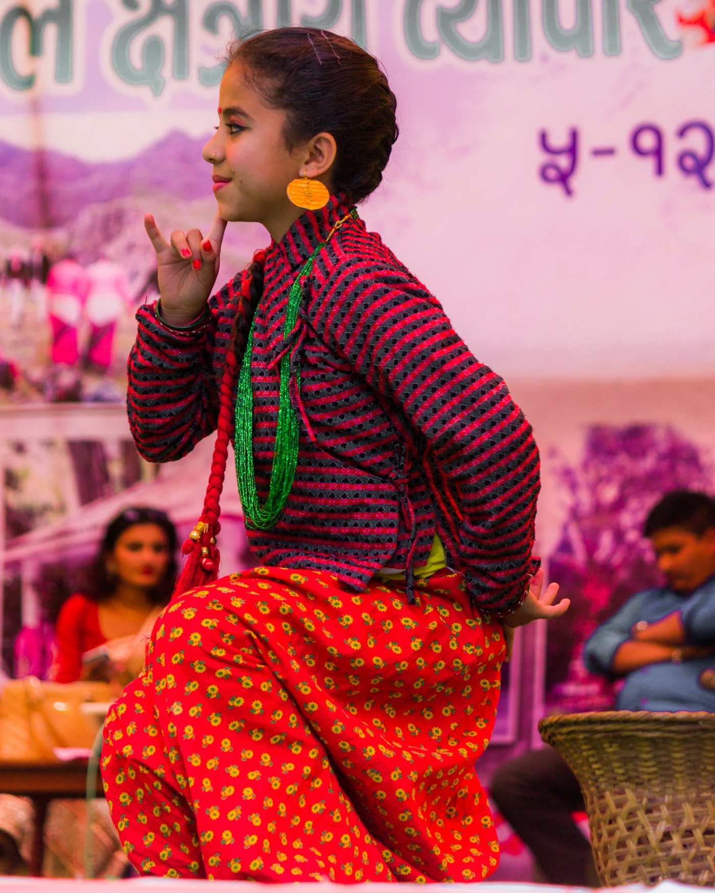 A child performing on stage in traditional dress
