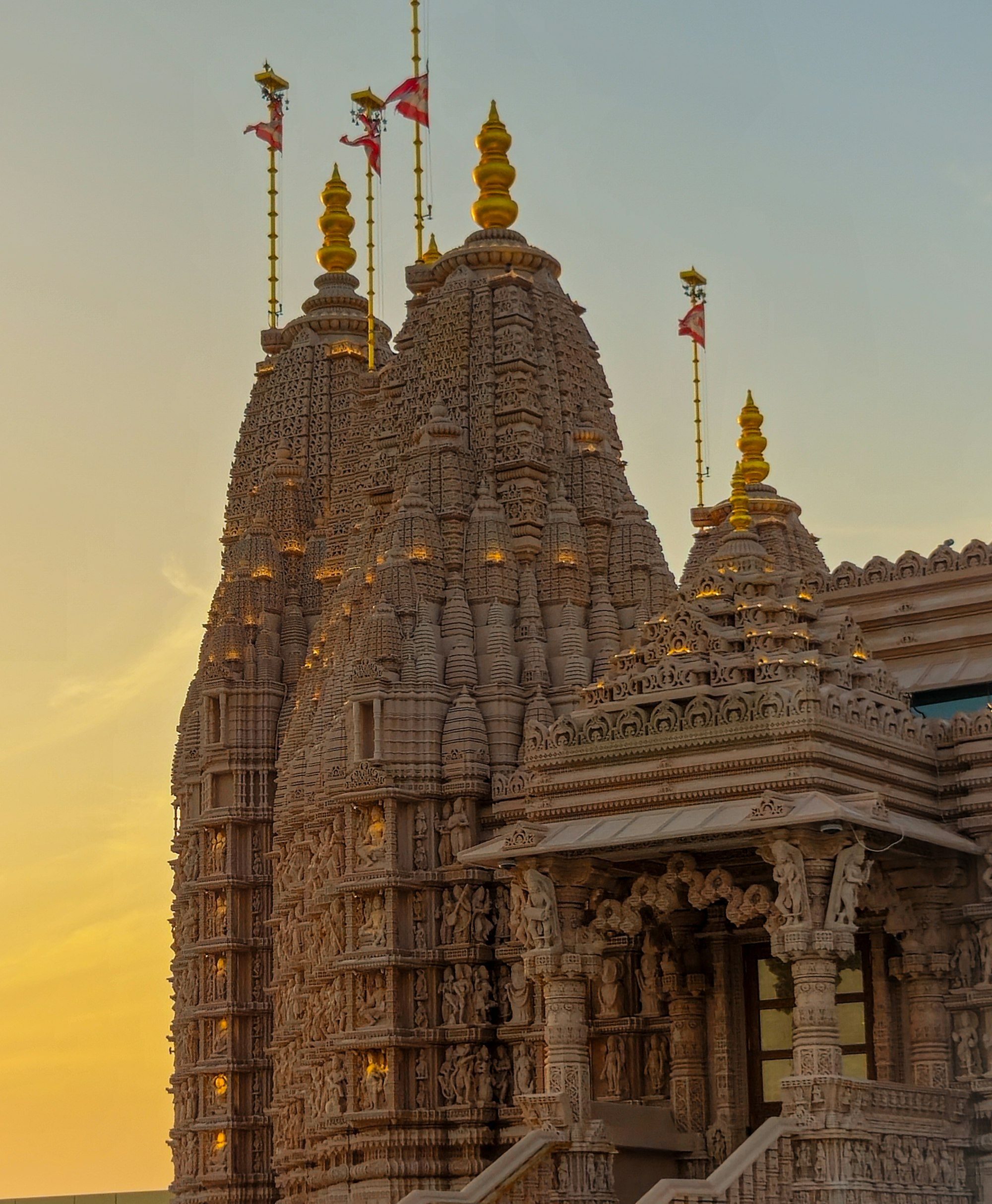 A mandir shikhar glowing at sunset