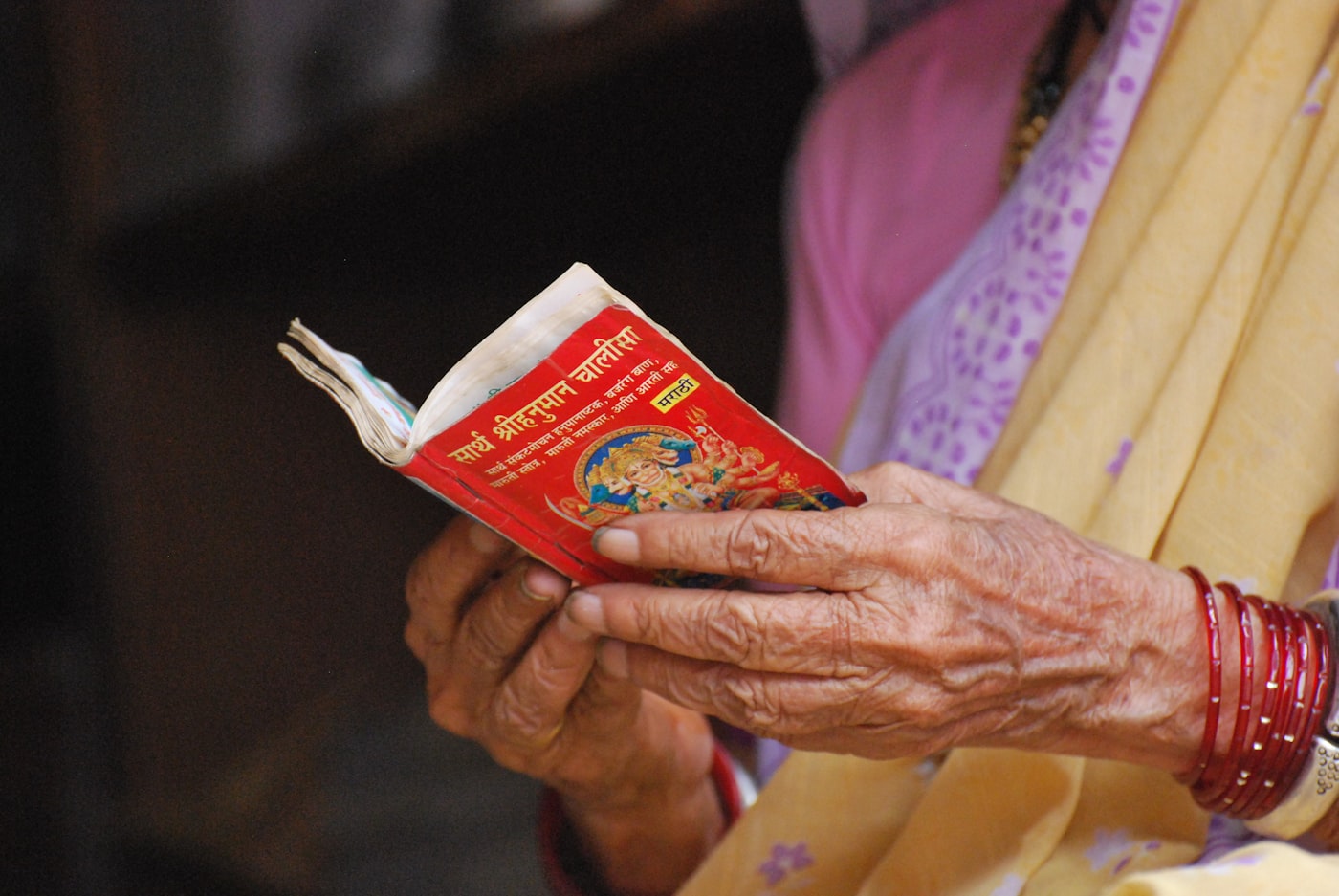 Hands holding an open devotional scripture